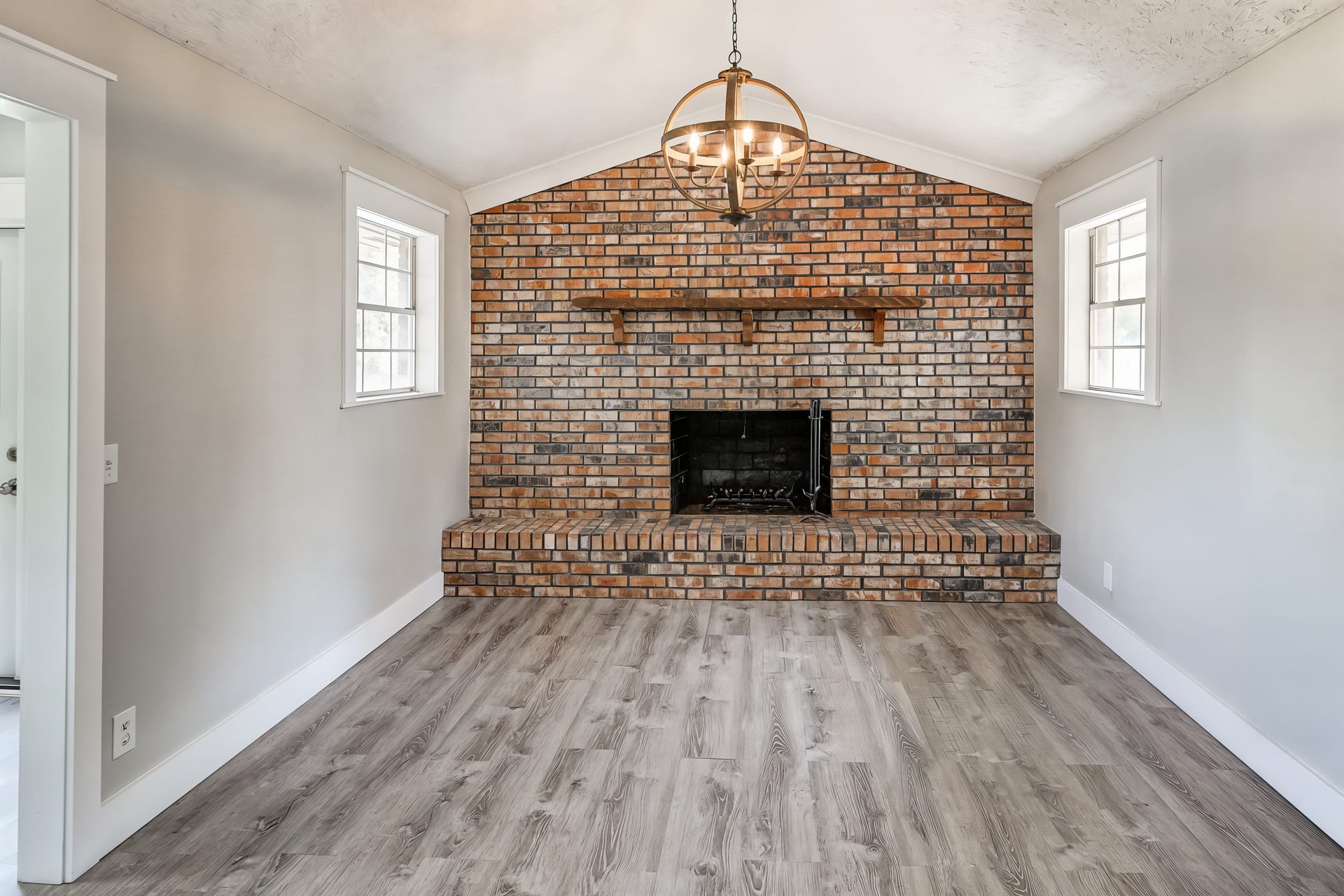 Bonus living room with a brick fireplace